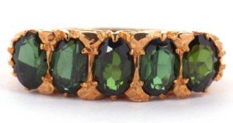 A 9ct green tourmaline ring, the five oval green tourmaline's, claw set with a scrolled gallery