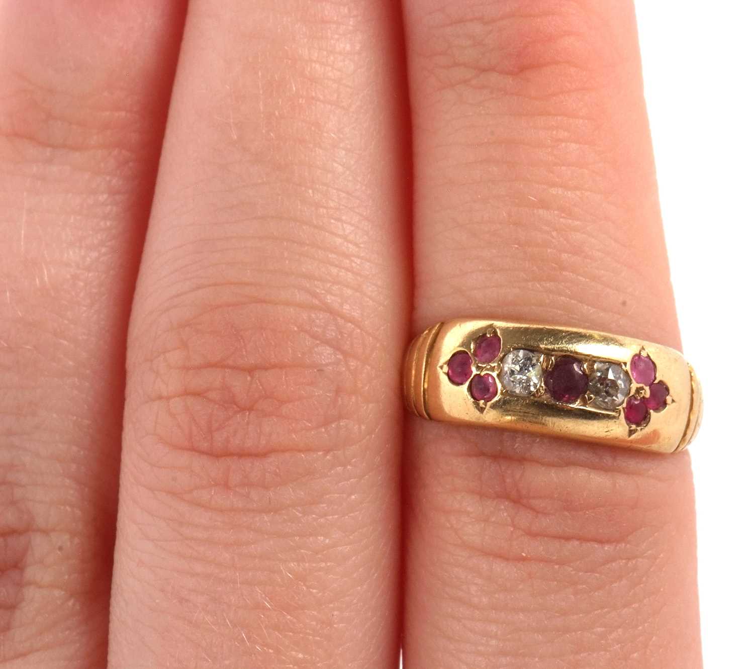 An 18ct ruby and diamond ring, the central round ruby set to either side with a round diamond and - Image 8 of 8