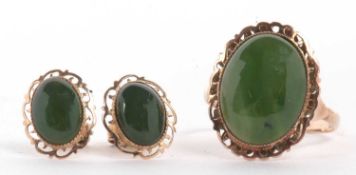 A green hardstone ring and matching earrings, the oval cabochon green hardstone, possibly