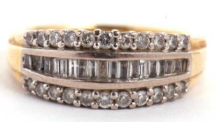 An 18ct diamond ring, set with a central channel of baguette cut diamonds with a row of small