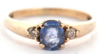 A 9ct sapphire and diamond ring, the oval pale blue sapphire set with a small round diamond to