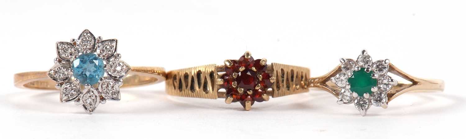 Three 9ct gemset rings to include a garnet cluster ring, size S-T, a topaz and white stone cluster