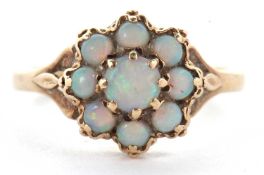 A 9ct opal cluster ring, the round opal cabochon cluster, claw mounted with split shoulders and