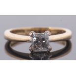 An 18ct princess cut diamond ring, wieght approx. 0.75cts, in a four claw mount to a plain band