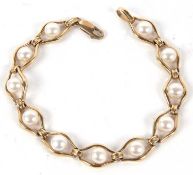 A 9ct and cultured pearl bracelet, the round cultured pearls, approx. 6.5mm diameter, set within