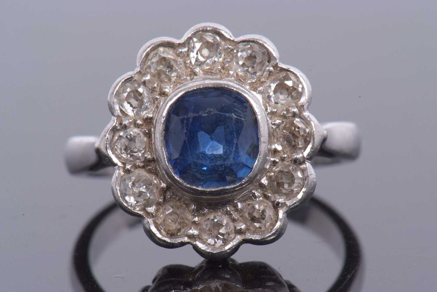 A sapphire and diamond cluster ring, the cushion shaped faceted sapphire is 7x7x4mm approx, bezel - Image 2 of 11