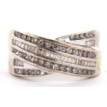 A diamond crossover ring, set with three crossover bands of alternating small round diamonds and