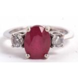 A 14ct white gold ruby and diamond ring, the oval mixed cut ruby, approx. 9.1 x 7.1 x 5.1mm, set