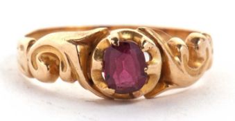A garnet ring, the oval garnet claw mounted to scrolled shoulders and plain unmarked band of