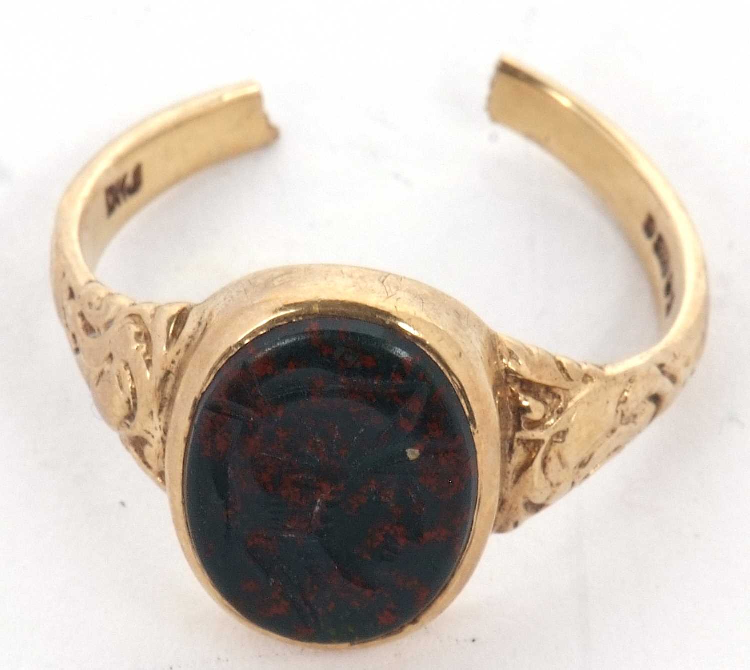 A 9ct bloodstone intaglio ring, the oval bloodstone intaglio, in rubover mount with repousse tapered - Image 2 of 2