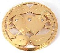 An 18ct gold and diamond set brooch, the round brooch with two love hearts and set with small