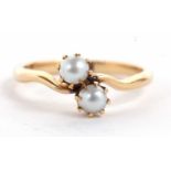 An 18ct cultured pearl crossover ring, the two pearls, claw mounted to a crossover style band
