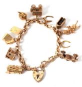 A 9ct belcher link charm bracelet with heart shaped padlock clasp (marks rubbed), with a selection