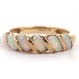 A 9ct opal ring, the five oval opal cabochons set at a 45° angle with a twist of gold separting