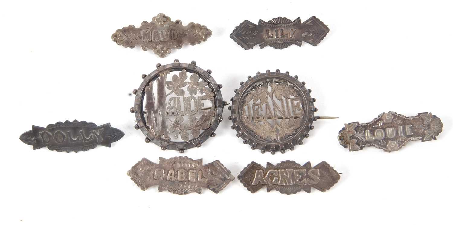 Eight early 20th century silver and white metal name brooches, to include Jeanie, Maude, Louie,