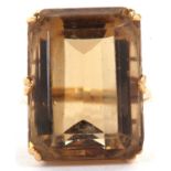 A citrine dress ring, the emerld cut citrine, approx. 21mm x 15.5mm x 11mm, in a six claw mount with