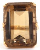 A citrine dress ring, the emerld cut citrine, approx. 21mm x 15.5mm x 11mm, in a six claw mount with