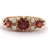 A 9ct garnet and cultured pearl ring, the three graduated round garnets interspaced with two small