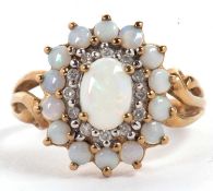 A 9ct opal and diamond cluster ring, the central oval opal cabochon surrounded by small round