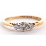 An 18ct and platinum three stone diamond ring, the three graduated round brilliant cut diamonds, set