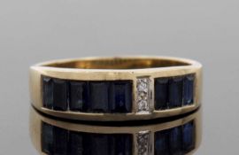 An 18ct sapphire and diamond ring, the channel set sapphires, offset with two small round