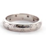 A platinum diamond eternity ring, the 3.8mm wide band set with small, single cut diamonds, stamped