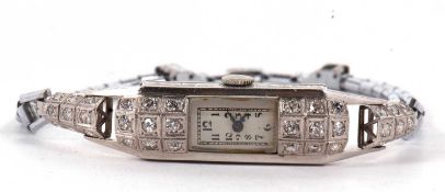 A lady's Art Deco diamond cocktail watch, the rectangular silvered dial with black Arabic numerals