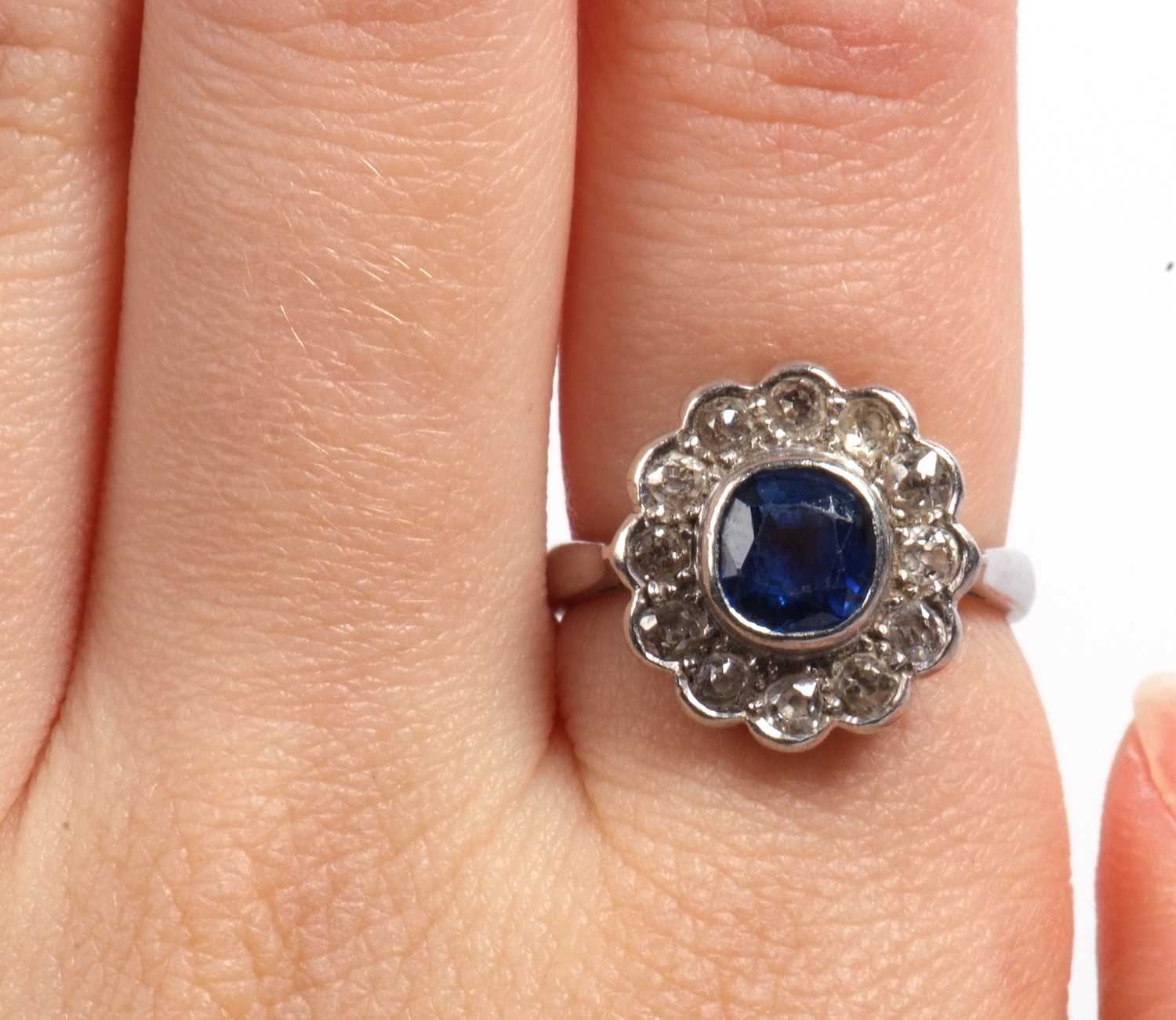 A sapphire and diamond cluster ring, the cushion shaped faceted sapphire is 7x7x4mm approx, bezel - Image 11 of 11