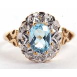 A 9ct topaz and diamond ring, the oval blue topaz claw mounted and surrounded by illusion set