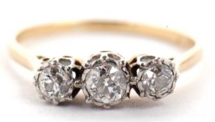 A platinum and 18ct three stone diamond ring, the three slightly graduated old cut diamonds in