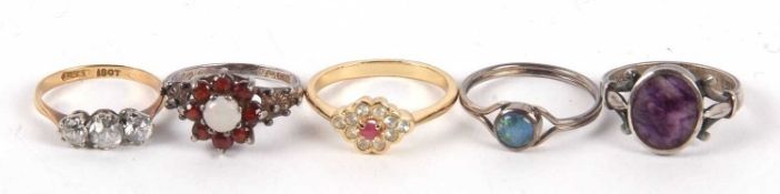 Five rings: a 9ct and white stone ring, an opal and garnet cluster silver ring, an opal triplet