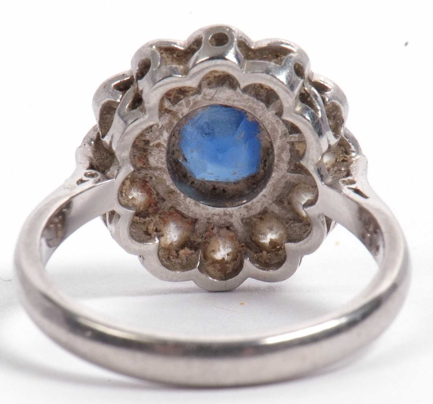 A sapphire and diamond cluster ring, the cushion shaped faceted sapphire is 7x7x4mm approx, bezel - Image 6 of 11