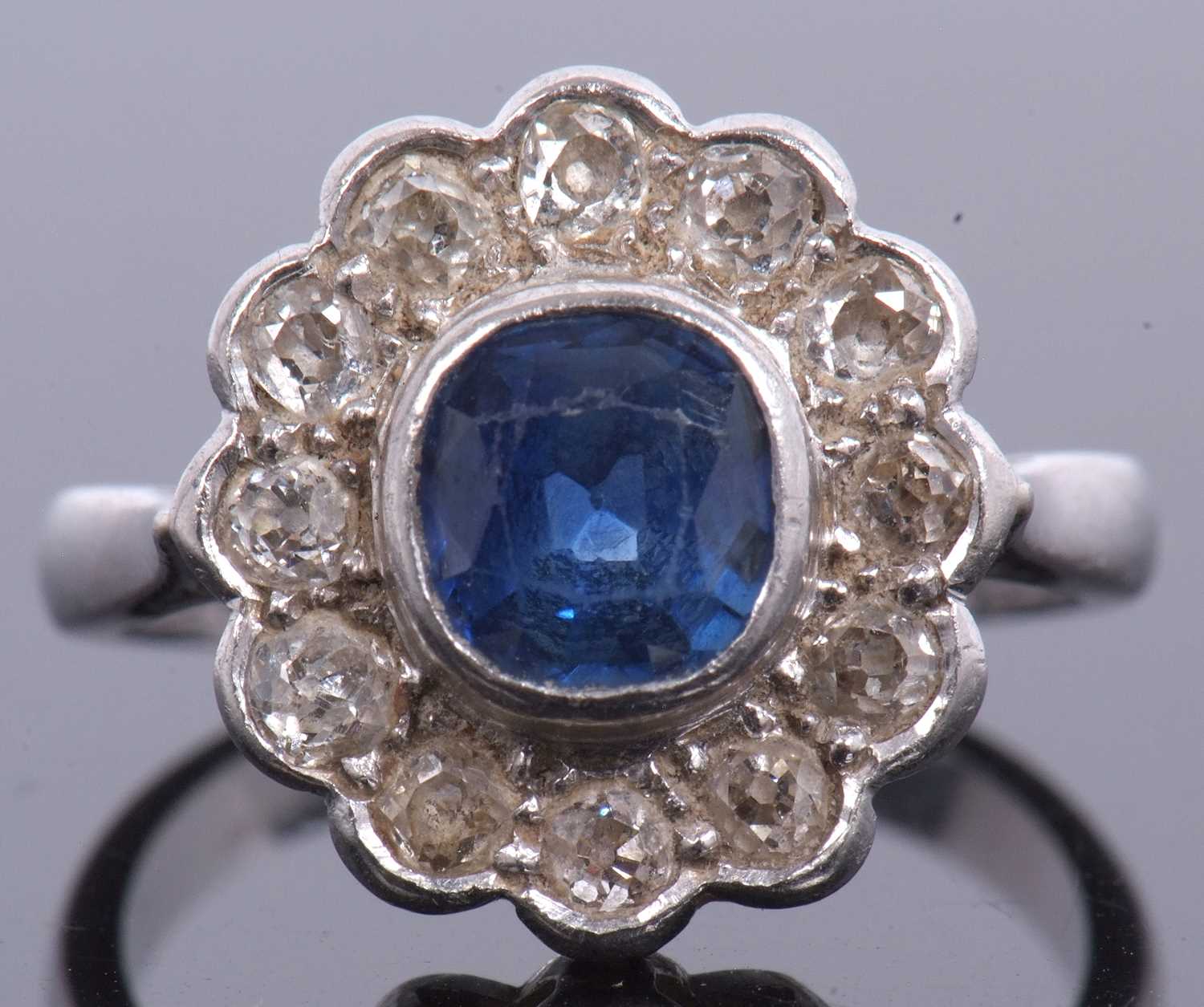 A sapphire and diamond cluster ring, the cushion shaped faceted sapphire is 7x7x4mm approx, bezel - Image 3 of 11