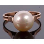 A cultured pearl ring, the cultured pearl approx. 1cm diameter, with cup and two claw mount, to a