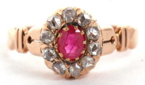 A ruby and diamond ring, the oval ruby surrounded by rose cut diamonds, all claw mounted with