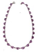 An amethyst necklace, the oval faceted amethysts, each approx. 8 x 6 x 4mm, each in a four claw