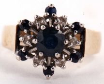 A 9ct sapphire and diamond ring, the central round sapphire surrounded by six small round diamonds