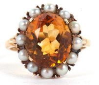 A 9ct citrine and cultured pearl ring, the oval citrine in a four claw mount and surrounded by small