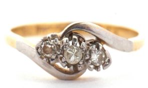 An 18ct and platinum three stone diamond crossover ring, total weight of diamonds estimated