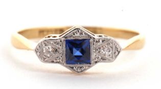 A platinum and 18ct sapphire and diamond ring, the central square mixed cut sapphire in a rubover
