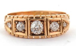 A Victorian five stone diamond ring featuring five graduated old brilliant cut diamonds each in a