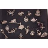 A quantity of white metal charms, to include a ballerina, a thistle, horse, dog, owl and moon, and