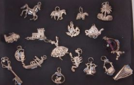 A quantity of white metal charms, to include a ballerina, a thistle, horse, dog, owl and moon, and