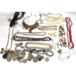 A mixed lot of costume jewellery to include bead necklaces, faux pearls, faux jet, brooches etc. and