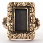 A Victorian mourning ring, the rectangular glazed panel with hairwork below, with rubover mount