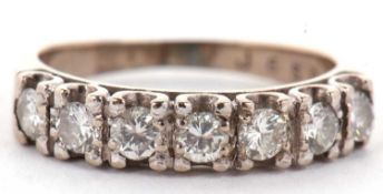 An 18ct white gold seven stone diamond ring, the seven round brilliant cut diamonds, total estimated