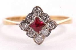 A platinum and 18ct ruby and diamond ring, the central square mixed cut ruby, set on the diagonal