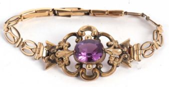 An amethyst bracelet, the central oval amethyst, collet mounted with scrolled repousse surround,