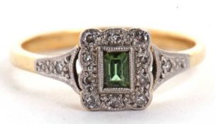 An 18ct peridot and diamond ring, the rectangular step cut peridot surrounded by small single cut