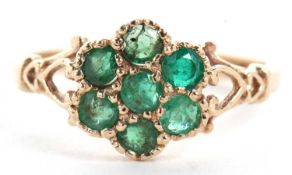 A 9ct emerald flowerhead ring, comprised of a cluster of seven round emeralds, all claw mounted with